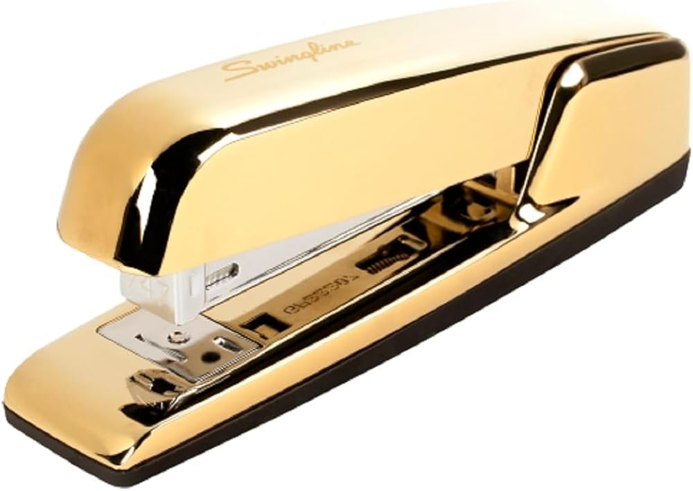 Swingline 747 gold stapler on a styled gold office desk