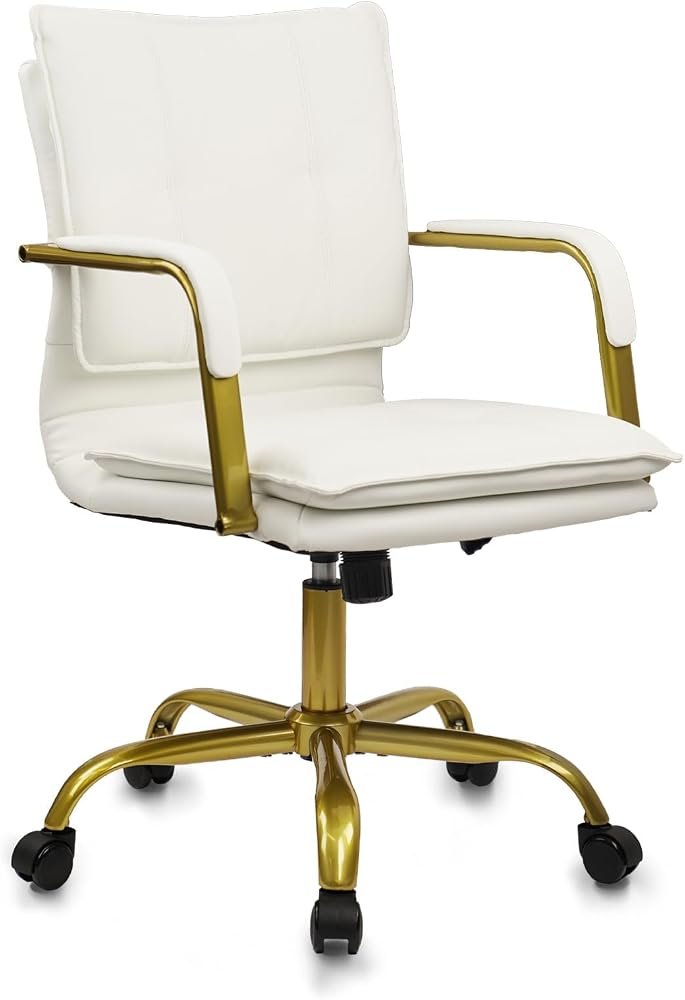 White leather executive chair with gold accents at a styled home office desk